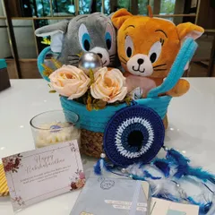 This Tom and Jerry themed hamper is for that classic love-hate sibling relationship. It features cute plushies, a scented candle, an evil eye dreamcatcher for protection, and a personalized Rakshabandhan card.