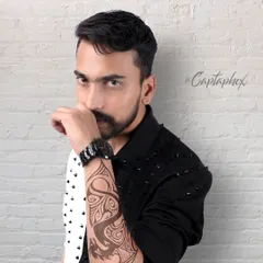 A modern male portrait with an intense, direct gaze. This headshot, taken against a white brick studio wall, focuses on expression and is perfect for building a diverse acting or modeling portfolio.