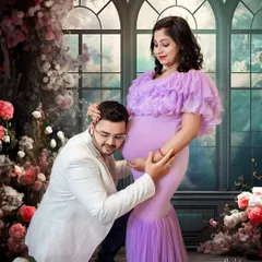 A tender moment as the father-to-be listens to the baby's heartbeat. This pose is always a favorite, and the dreamy floral set makes it even more special.