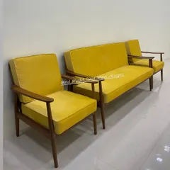 A side view of the vibrant yellow mid-century modern sofa set, showing the clean lines of the solid wood frame and the plush cushions.