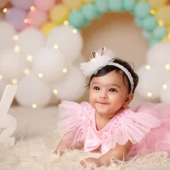 Wrapped in love, filled with joy. This half-birthday shoot with a pastel rainbow backdrop celebrates six months of sweetness.