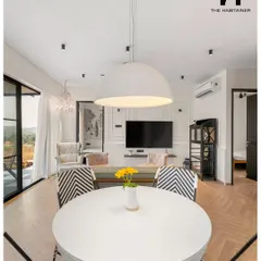 Step inside a chic prefab home we designed in Denkanikotta. This view of the open-plan living and dining area highlights the warm, elegant, and comfortable interiors we can create, proving that modular construction offers complete design freedom.