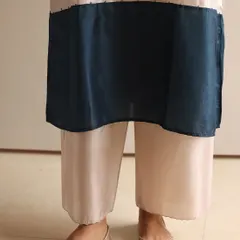 When comfort meets sophistication. A close-up of simple, elegant gold juttis paired with silk color-blocked pants, a perfect look for all-day wear.