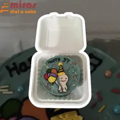 This fun bento cake was designed for a 37th birthday celebration. It features a cute, hand-drawn character holding balloons, complete with a party hat and colorful sprinkles, all packed in a convenient to-go box.