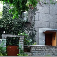 The Sen Residence in Bangalore, built on a corner plot, features a distinctive curved wall finished with grit plaster. This project demonstrates our ability to create unique architectural statements that respond to the specific constraints and opportunities of a site.