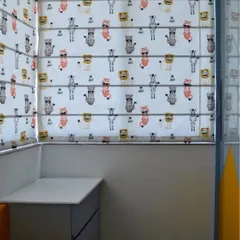 A detail of the custom Roman blinds with a playful animal pattern, adding a touch of fun and personality to the kids' room window.