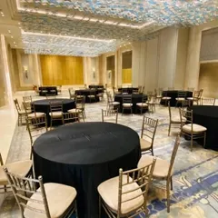 We take care of the entire setup, including tables and chairs. This is the dining area we arranged for a house warming at Lodha World Towers, with elegant black linens and chiavari chairs.