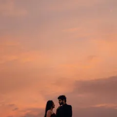 A breathtaking sunset silhouette. This is the kind of epic, romantic shot that makes a pre-wedding album truly special. The gown's shape stands out beautifully against the colorful sky.
