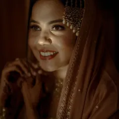 Bathed in a golden glow, this bride's happy expression is absolutely captivating. I use dramatic lighting to create portraits that are both beautiful and full of emotion.