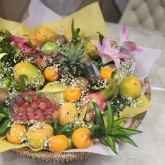 Another angle of our vibrant fruit basket, showcasing the mix of tropical fruits like dragon fruit and pineapple alongside classic favorites. The arrangement is perfect for making a lasting impression.