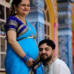 A tender moment between the couple, with the father-to-be listening to the baby bump. This is a classic pose that beautifully captures the anticipation of parenthood.