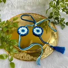 The Rakhi and Lumba set displayed on a golden plate.