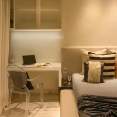 The client brief was "I want a black room," a common request from teenagers. My solution was to use black smartly, pairing a large platform bed and a grey stucco curved wall for his TV and Playstation with a bright study area near the window.