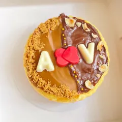 Celebrating love with a personalized touch. This eggless New York Baked Cheesecake is customized with the couple's initials, making it a perfect anniversary or engagement dessert.