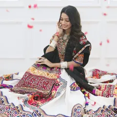 Surrounded by a shower of petals, this Navratri look is pure magic. The traditional outfit and jewelry are the stars, so we kept the makeup fresh and glowing.