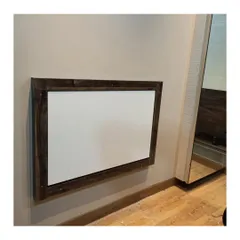 A wall-mounted study table in its folded-up position. When not in use, it sits flat against the wall, making it perfect for bedrooms or living areas where a permanent desk isn't practical.