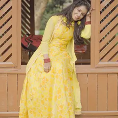 A relaxed pose during an outdoor shoot. The model is wearing a yellow Anarkali-style dress, showing how I capture both posed and in-between moments.