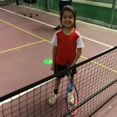 A future star in the making at our Off The Mark facility. We use smaller nets and courts to help our mini tennis players learn the game in a fun and accessible way.