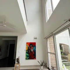Our gallery is a 7,000 sq ft modern space with high, light-filled ceilings, designed to let large-scale artworks breathe. This piece, a vibrant portrait of Jimi Hendrix, shows how the architecture itself becomes part of the viewing experience.