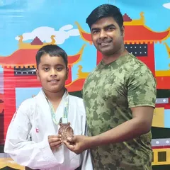 Celebrating a bronze medal win at the Open National Karate Championships. Every medal represents countless hours of dedication.