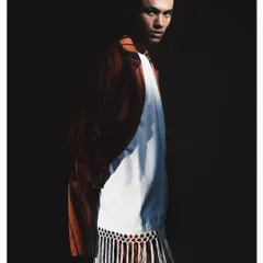 A striking portrait from my 'Silhouette' series, using chiaroscuro lighting to carve the model out of the darkness. This high-contrast technique emphasizes the form of the striped suit and the subject's intense gaze, showcasing my love for dramatic light.