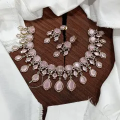 A stunning AD necklace set laid out to show its full design. This piece is available in multiple vibrant colors like ruby red, emerald green, pastel blue, and sapphire blue, featuring teardrop-shaped stones.