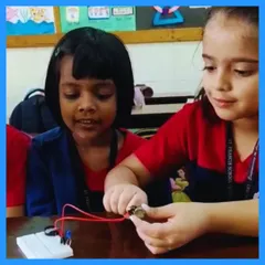 Our youngest learners get right into the action. Here, two students discover the magic of a simple circuit, learning how a battery can power a small motor. These foundational moments are key to sparking a lifelong interest in STEM.