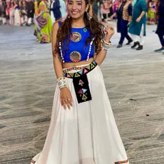 The full Navratri look, ready for Garba. The makeup is designed to be long-lasting and vibrant, complementing the colorful, traditional outfit with its mirror work and playful details.