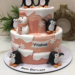 A super cute penguin-themed cake for a first birthday. My client requested a peach color combination with adorable penguins, a snowman, and snowflakes as the main elements. This 3kg cake was a unique Rabri Elaichi flavor.