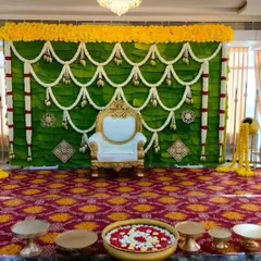 For a truly traditional feel, we created this baby shower stage using a backdrop of fresh banana leaves accented with garlands of chendu hoovu (marigolds). It's a simple, natural, and elegant look.