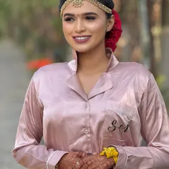 A behind-the-scenes shot of the bride getting ready. Even in her prep outfit, the hair and makeup are already coming together beautifully.