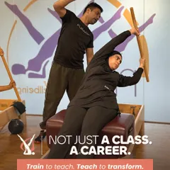 This is more than a class. It is a career. I train you to become a teacher who can truly transform lives. This image shows the hands on mentorship you will receive, guiding you to master the apparatus and the method.