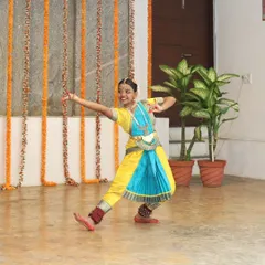 A young Bharatanatyam dancer in a vibrant costume during our "Platform Performances" for young artists. We are committed to nurturing the next generation of performers.