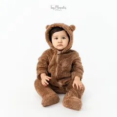 Sweeter than honey. This little one dressed in a fuzzy bear suit makes for an irresistibly cute and classic baby portrait against a clean white background.