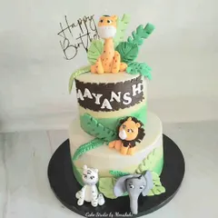 A fun, two-tier jungle adventure cake made for a toddler's birthday. I loved crafting the cute, friendly lion, giraffe, tiger, and elephant to create a delightful scene for the little one's big day.