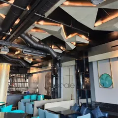 An overview of the NX Lounge, showcasing the interplay of the parametric ceiling, custom furniture, and curated art. Every element is designed to contribute to a cohesive and immersive experience, balancing bold design with comfortable seating arrangements.