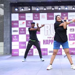 Leading the runners through essential stretches and warm-up exercises on stage. It's crucial to get everyone's muscles ready for the run, and we make it fun with Zumba.