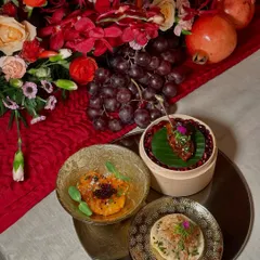 A trio of appetizers from a multi-course dinner, featuring Jiang's chicken, an Asian prawn and crab ceviche tostada, and a delectable bite served in a mini bamboo steamer.