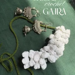 A flat lay of my crochet gajra next to some pretty jhumkas to show how well it pairs with traditional jewelry. The white flowers will always stay this bright and lovely.