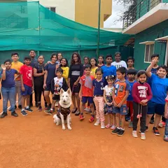 A great group photo with my students and our furry friend. Coaching is a challenging but incredibly fun part of my life, and I love the energy my players bring to the court every day.
