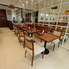 Another angle of the restaurant, highlighting the rows of custom-made dining chairs with cane backs and upholstered seats. Consistency and quality across a large order are things I guarantee for all my commercial projects.