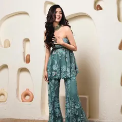 This embroidered peplum and flared trouser set on Geethika is a fantastic alternative to a traditional lehenga for a wedding event. It's chic, comfortable, and incredibly stylish.