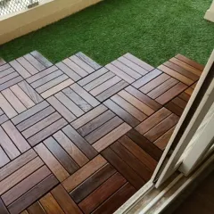 A close-up of the interlocking wooden deck tiles I use for balcony and terrace flooring. They provide a warm, natural look and are designed for durability and easy installation over existing surfaces.