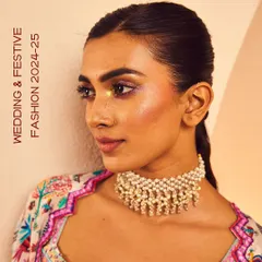 Don't miss the drama this wedding season. A model wears our classic ghungroo pearl choker, a handcrafted piece that adds a statement touch to any festive or wedding fashion look.