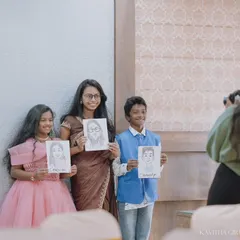 Capturing me in action. Here I am photographing happy family members showing off their portraits at an event, documenting the joy of the day.