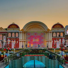 We transformed this venue into a picturesque European town square for a truly unique wedding theme. The detailed facades, water feature, and sunset backdrop created an unforgettable ambiance for the celebration.