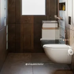A close-up view of the wall-mounted toilet and the seamless integration of the shower's glass partition. These details contribute to a clean, minimalist aesthetic that is both modern and functional.