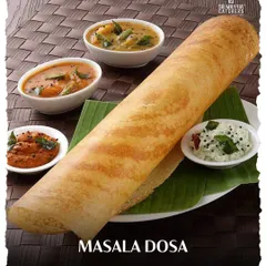 The quintessential Masala Dosa, perfectly golden and crisp. We serve it the traditional way on a banana leaf with flavorful sambar and a selection of freshly ground chutneys.