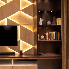 A stunning geometric backlit TV wall panel serves as the focal point of this living room. The integrated LED strips are fully dimmable and tunable.