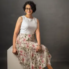 For this headshot, we chose a brighter, more casual look with a floral skirt. It shows that professional portraits can reflect your personal style while still looking polished and ready for business.